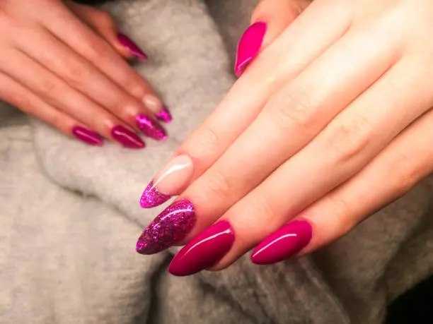 Close up of Fake Nails, Acrylic Nails, Gel nails on a woman's hand in neon colours